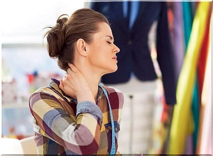 woman holds painful neck