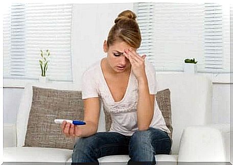 Worried woman after taking a pregnancy test