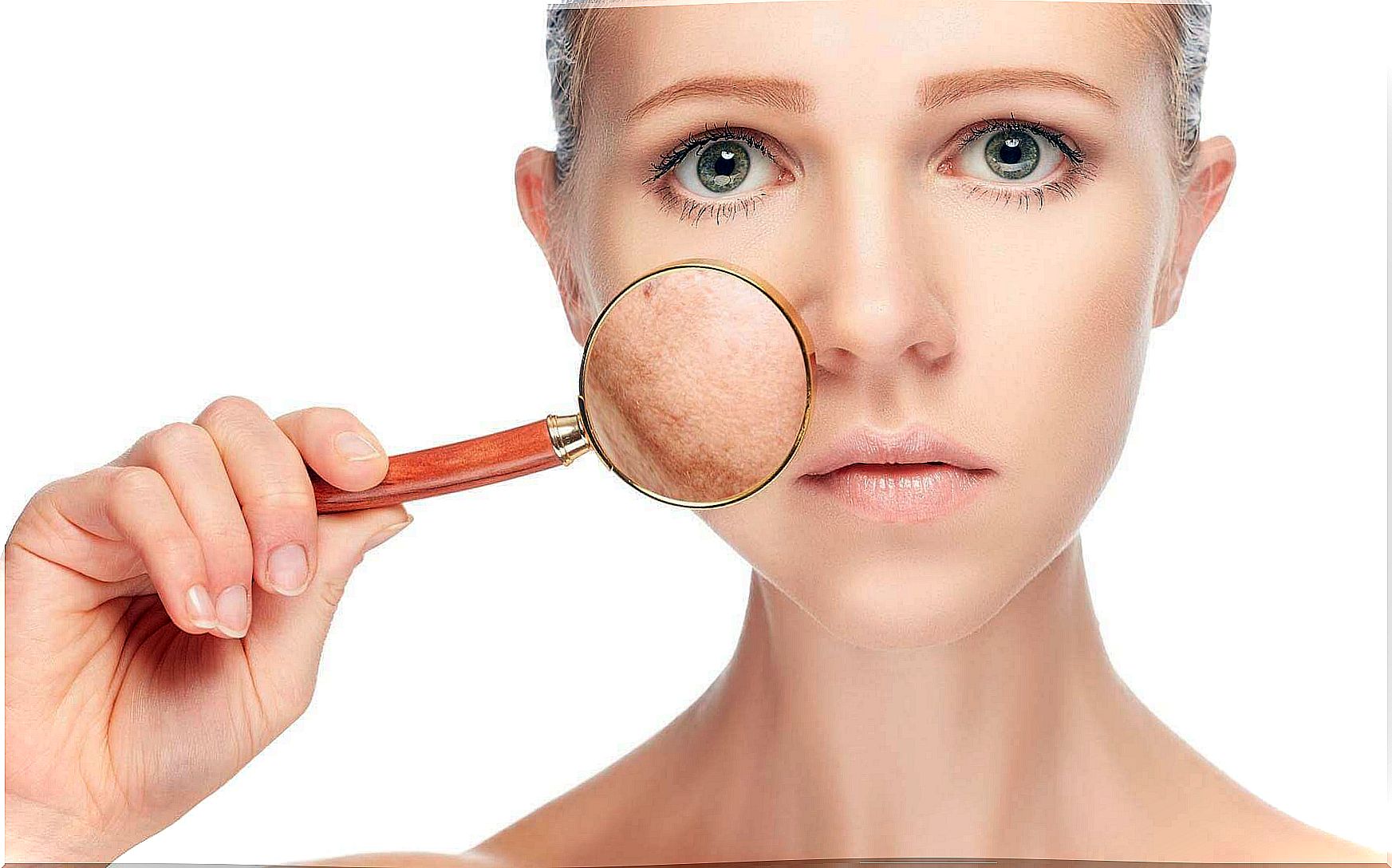 Woman holds magnifying glass to her skin