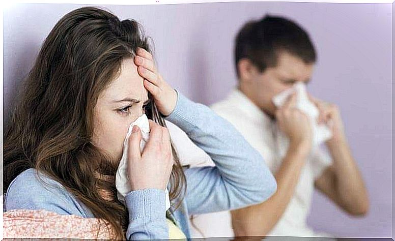 man and woman with handkerchiefs in front of their noses